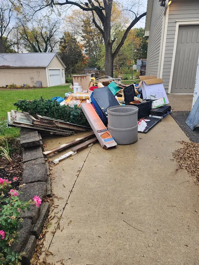 Dumpster being loaded with debris for Demolition Dumpster Rental in Milford